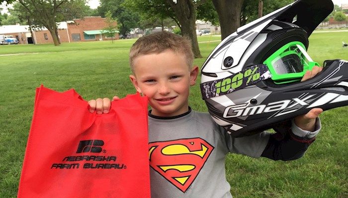 Student with his new helmet and gear from Farm Bureau