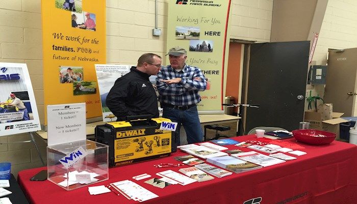 Adam Peterson (Central RDM) visits with Dodge County President, David Saalfeld at booth.